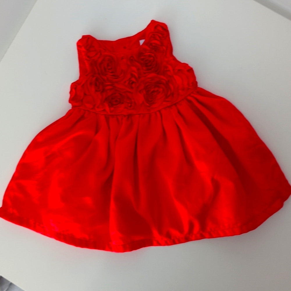 Red dress with flower detail on the bodice. Size newborn